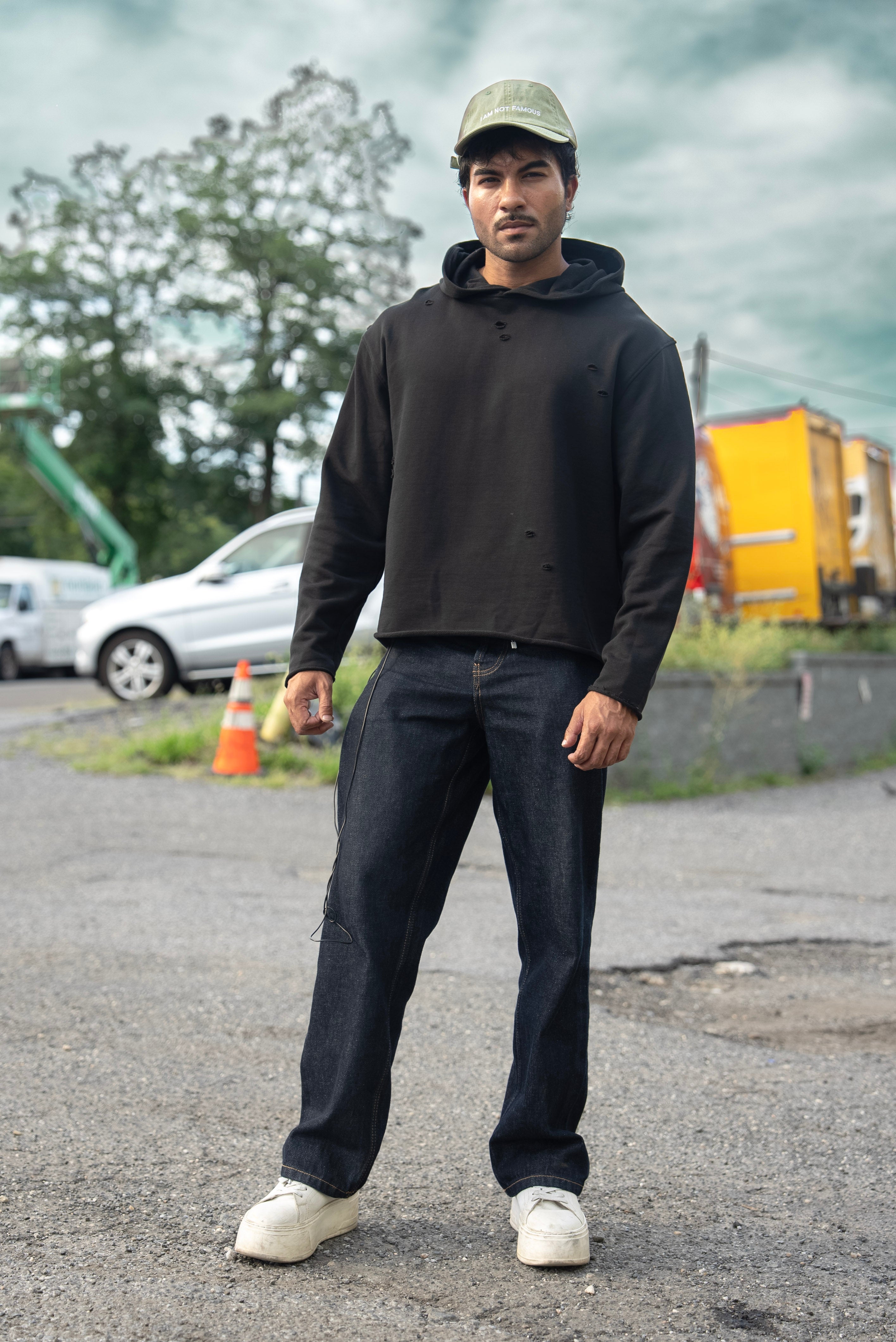 Stealth Pump-Cover Hoodie in Black, front view showing the cropped boxy fit and distressed detail