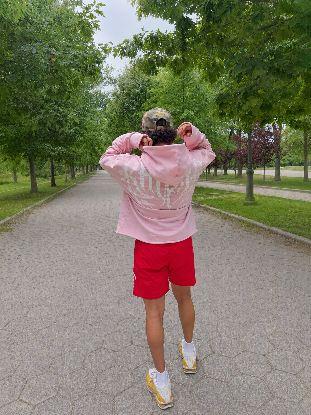 Stealth Pump-Cover Hoodie in Pink on model — hood pull