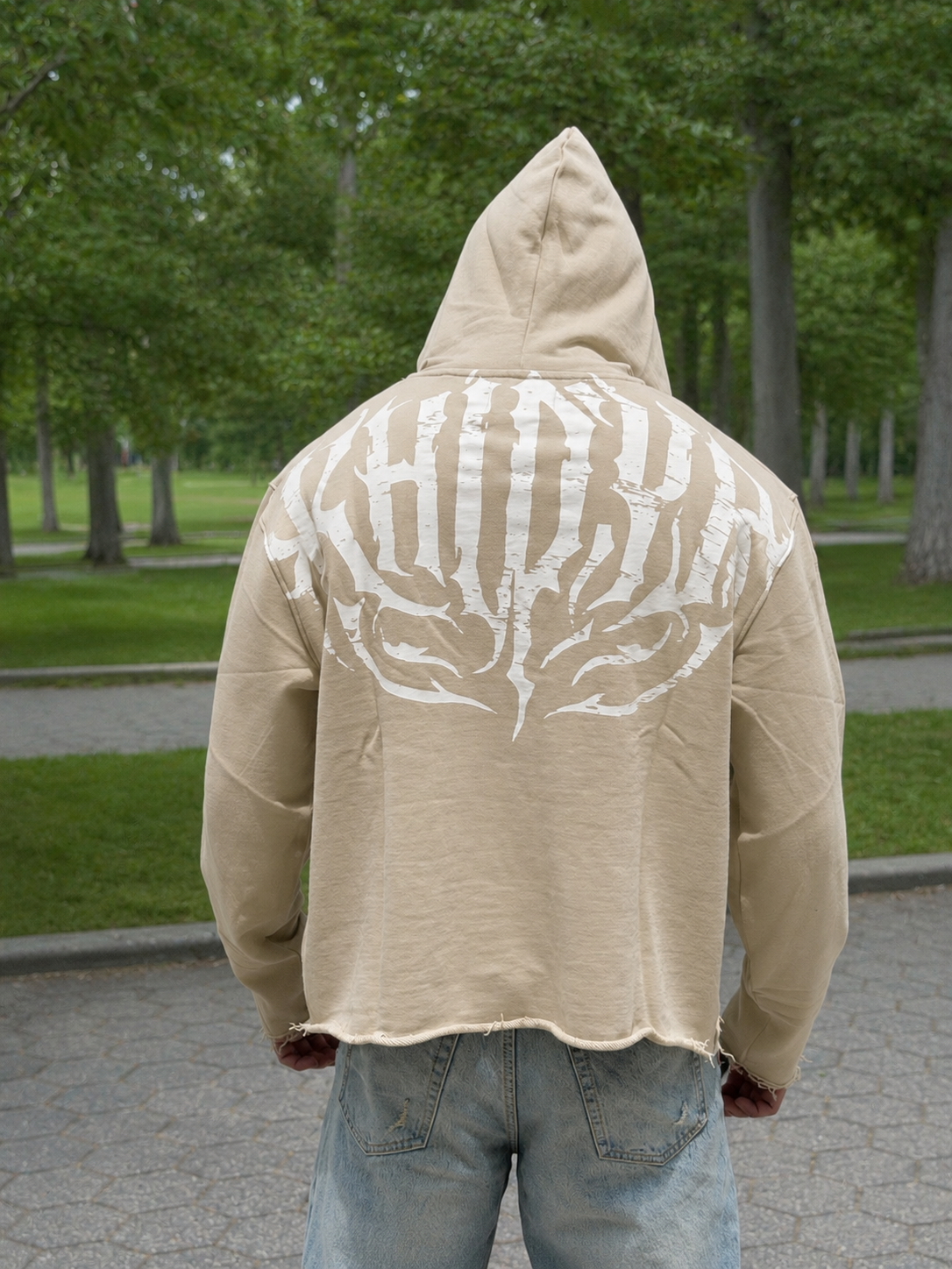 Stealth Pump-Cover Hoodie in Beige on model — hood up, back print