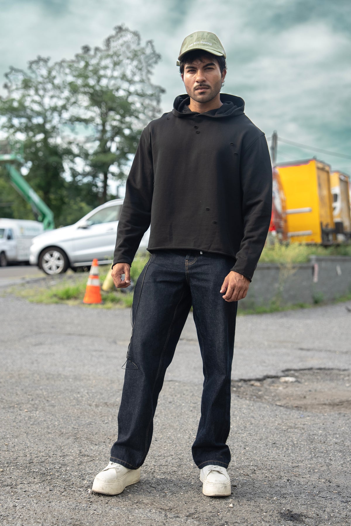 Stealth Pump-Cover Hoodie in Black, front view showing the cropped boxy fit and distressed detail