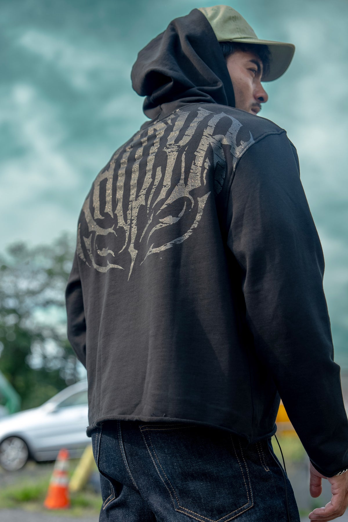 Stealth Pump-Cover Hoodie in Black, back view with the hood up showing the KHIDYR back print