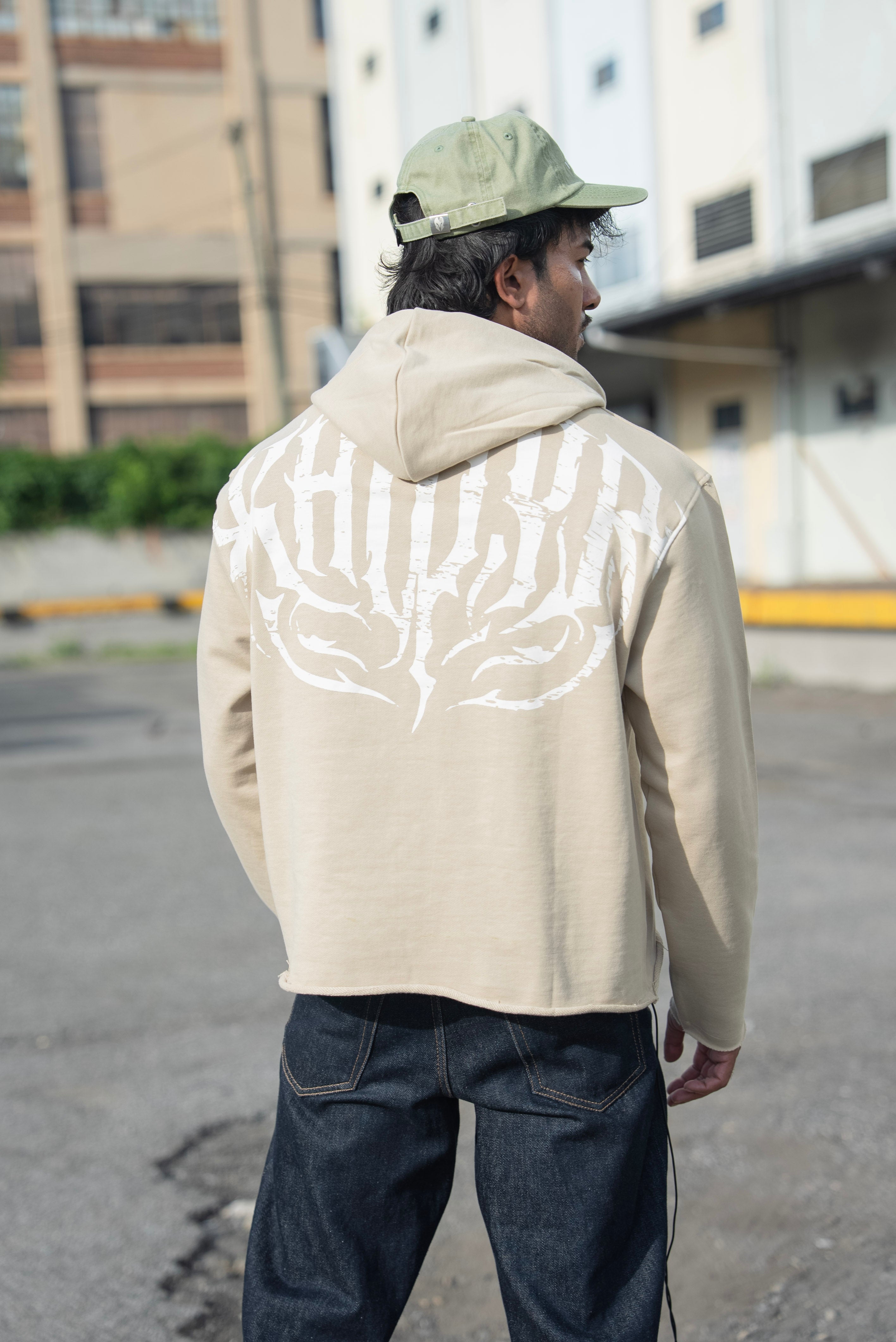 Stealth Pump-Cover Hoodie in Beige, back view showing the white KHIDYR print and cropped raw hem